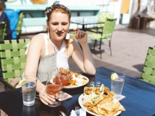 Woman having lunch at the rough bar in Mendocino