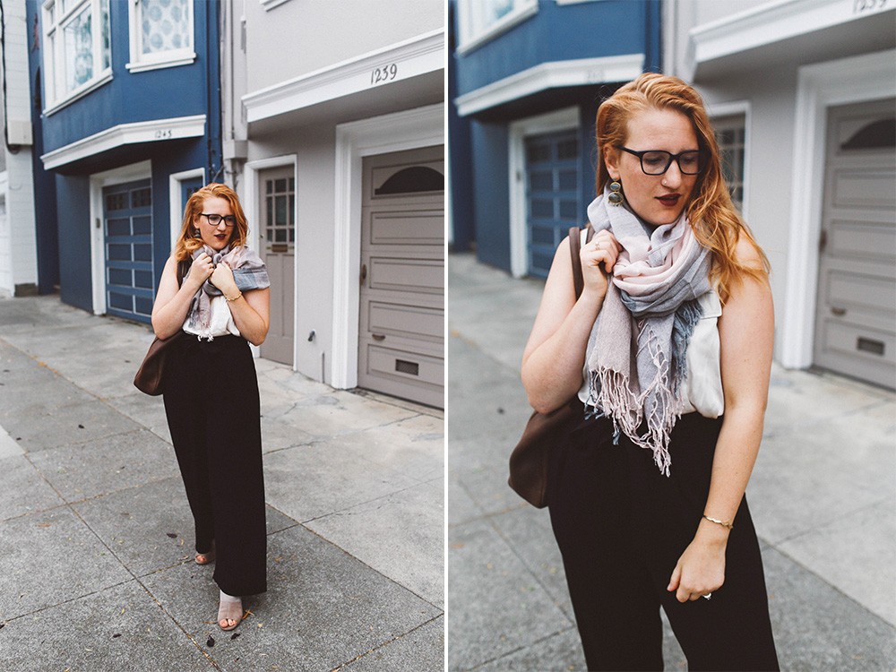 pink scarf black wide leg pants woman red hair glasses