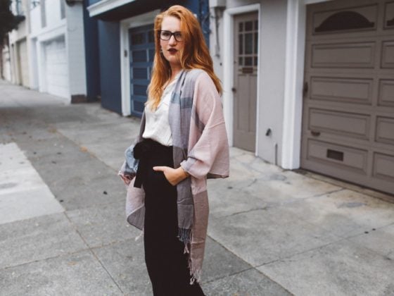 pink scarf black wide leg pants woman red hair