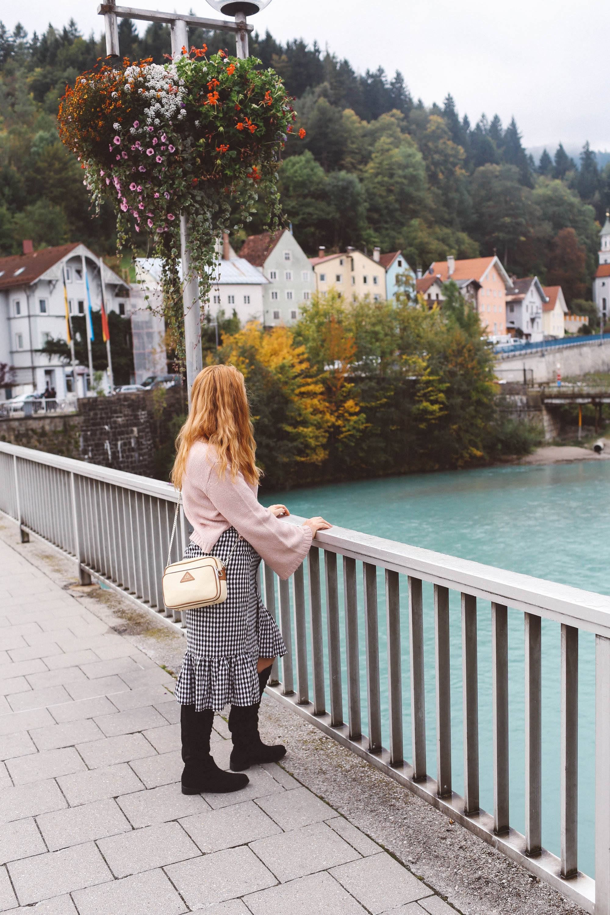 Füssen, Germany pink sweater gingham skirt river water houses