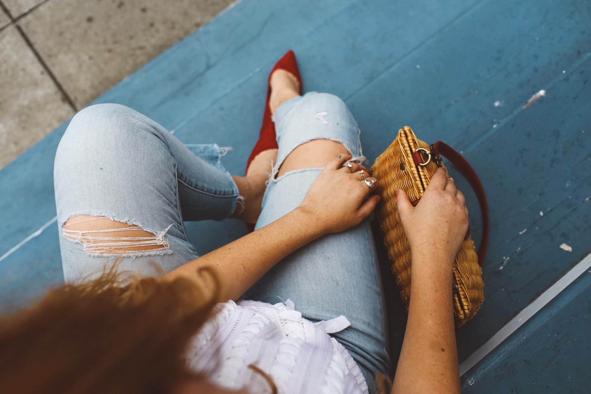 red heels wicker purse jeans