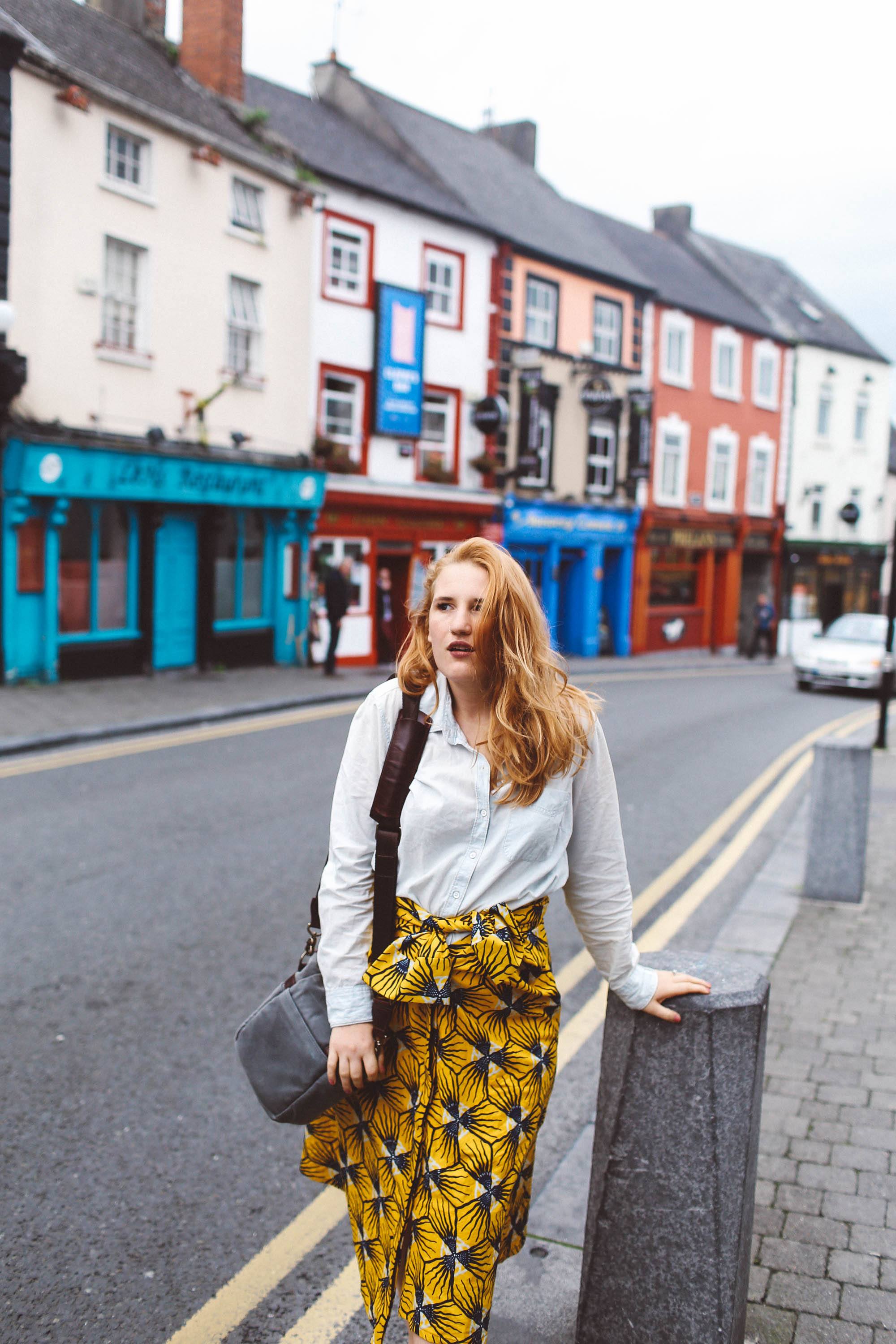 kilkenny ireland woman yellow skirt ona bag