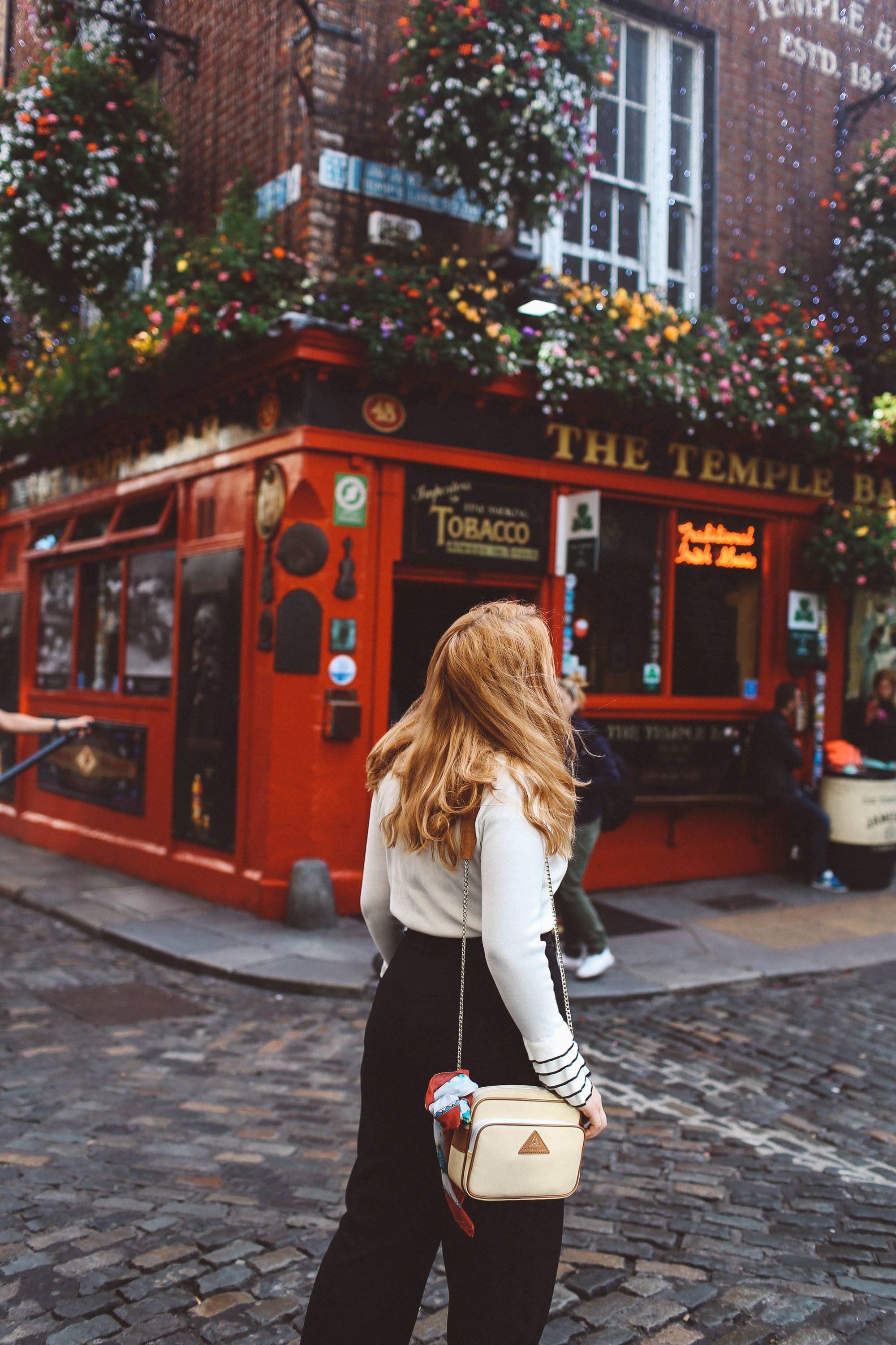 temple bar woman white sweater black pants