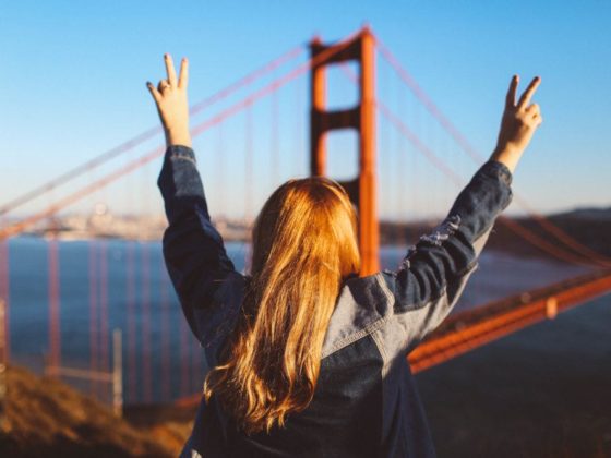 woman peace sign Golden Gate Bridge San Francisco