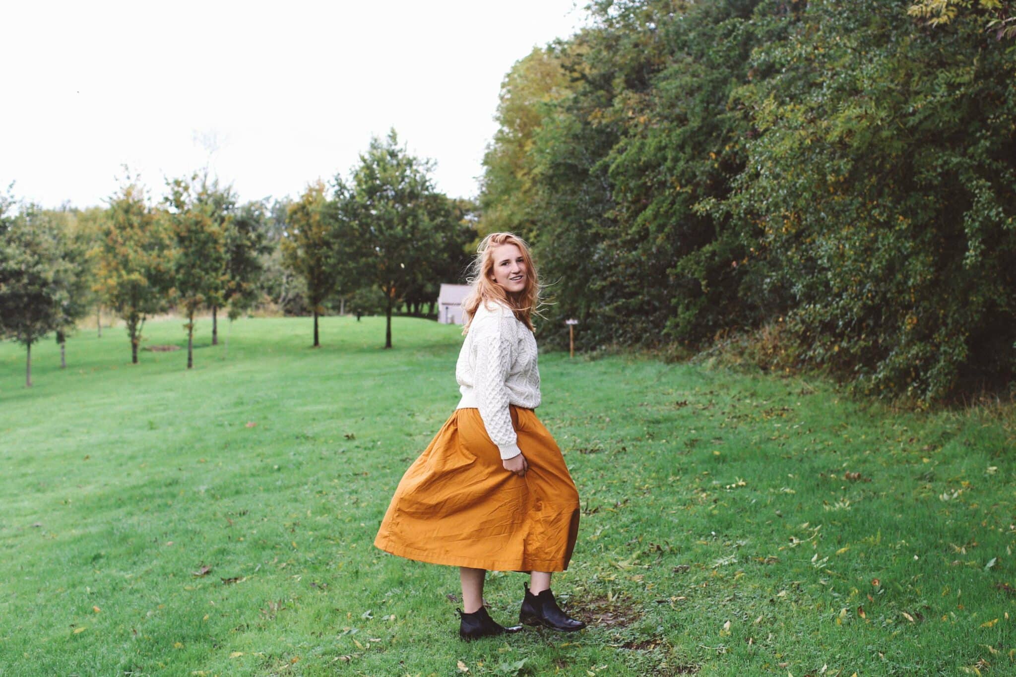 woman white sweater orange midi skirt ireland