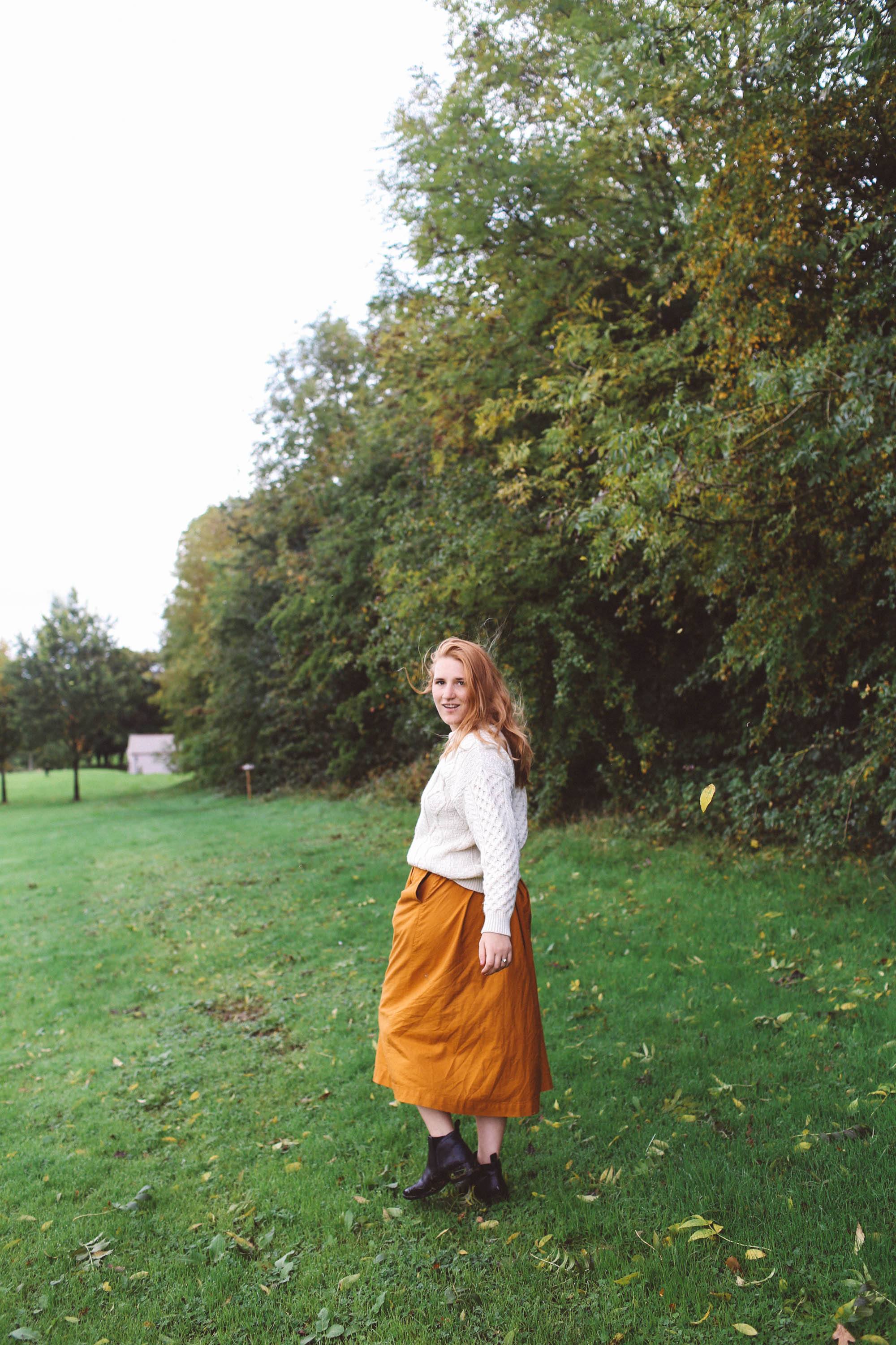 woman white sweater orange midi skirt ireland