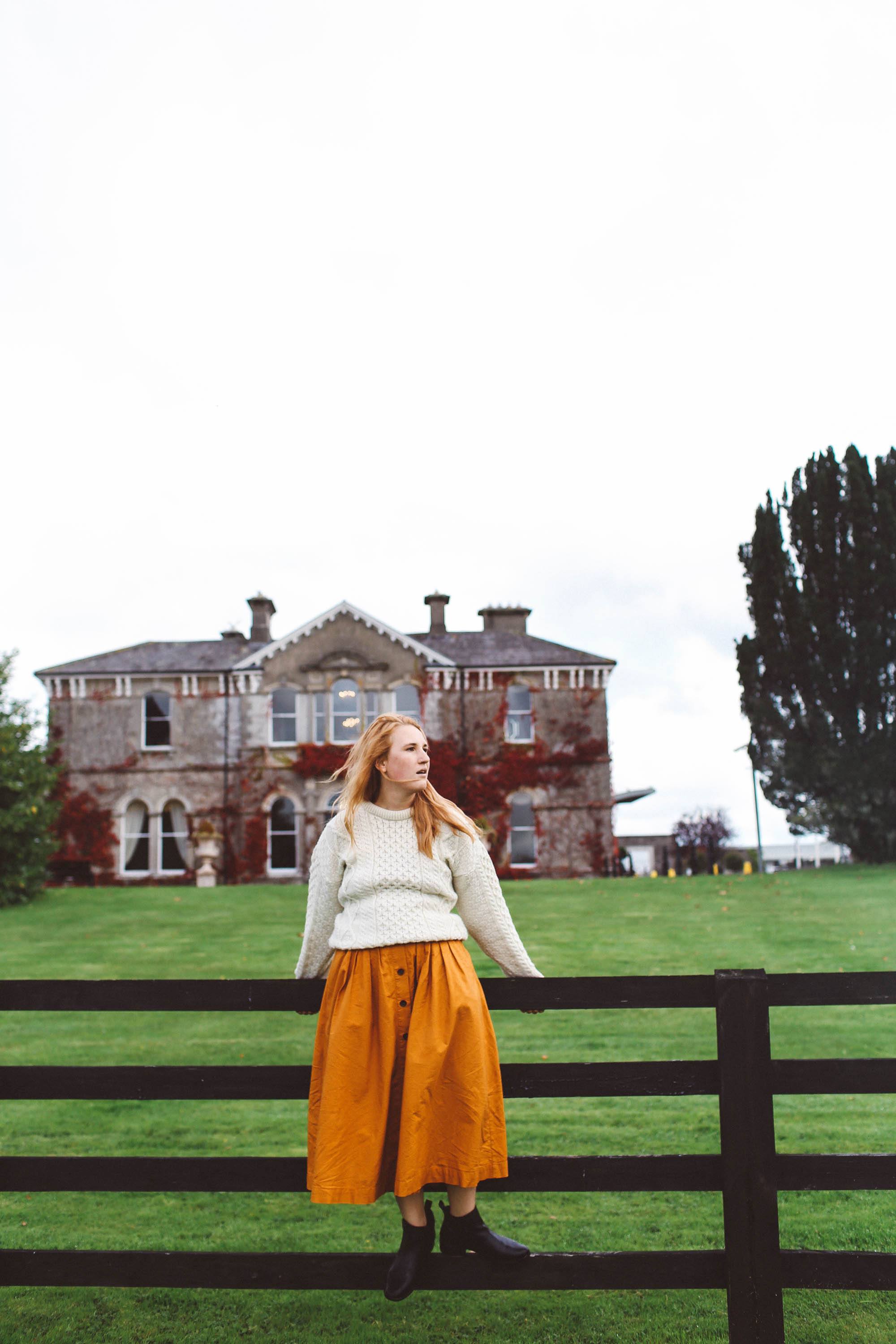 woman white sweater orange midi skirt lyrath estate