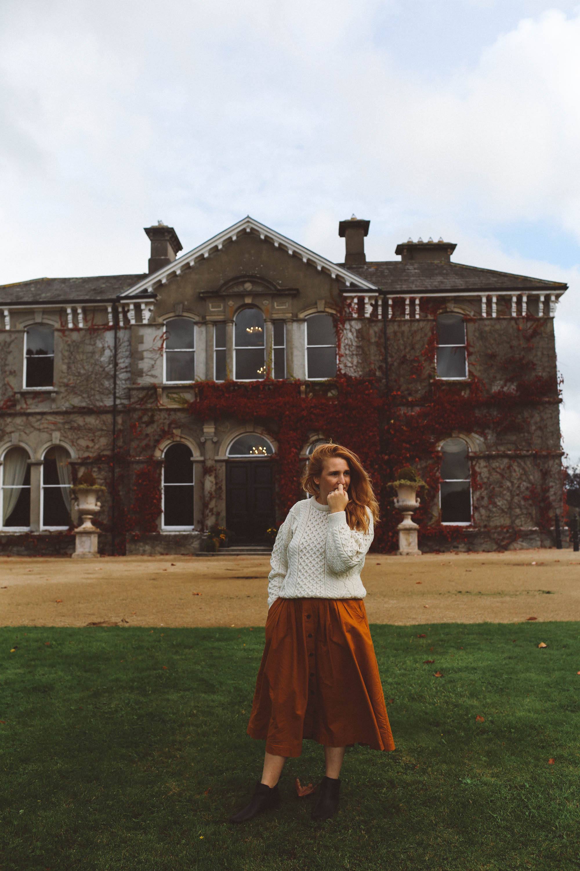woman white sweater orange midi skirt ireland lyrath estate