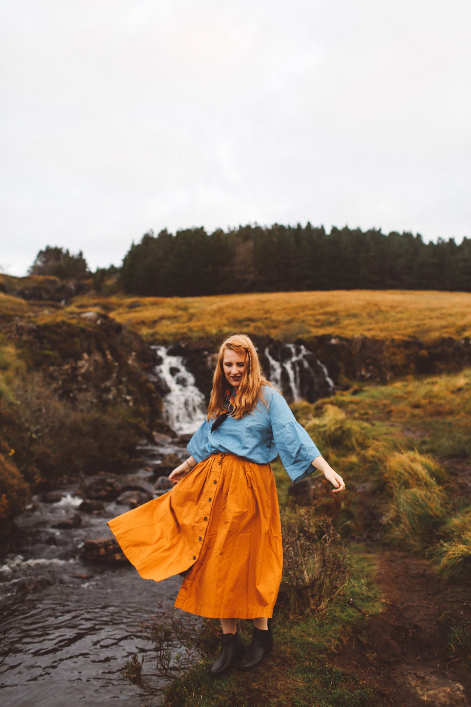 fairy pools isle of skye orange skirt woman