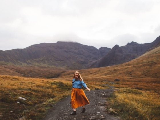 fairy pools isle of skye orange skirt woman