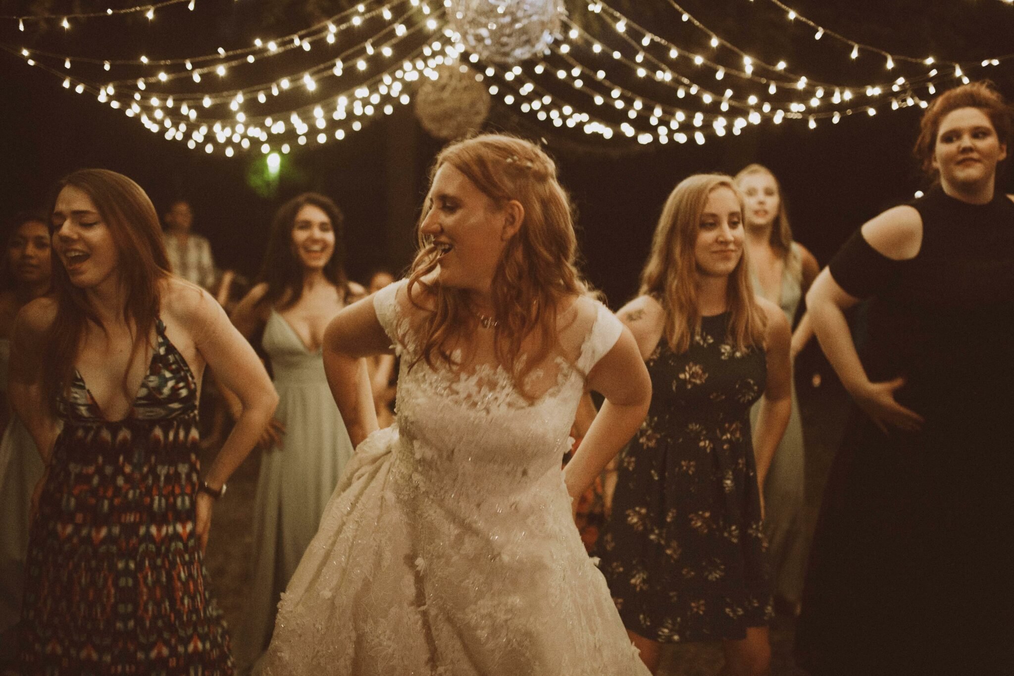 bride dancing wedding string lights