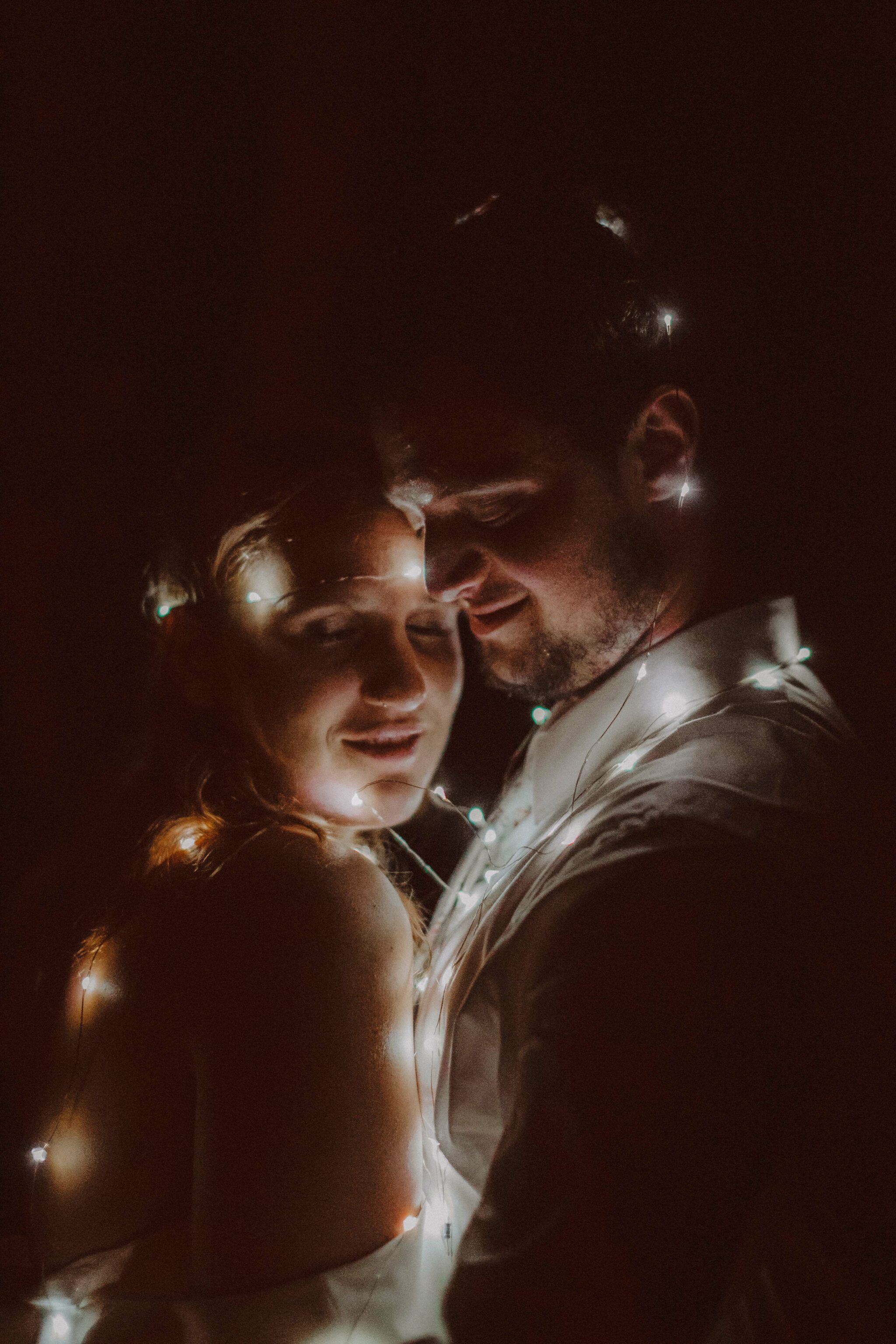 bride groom string lights portrait