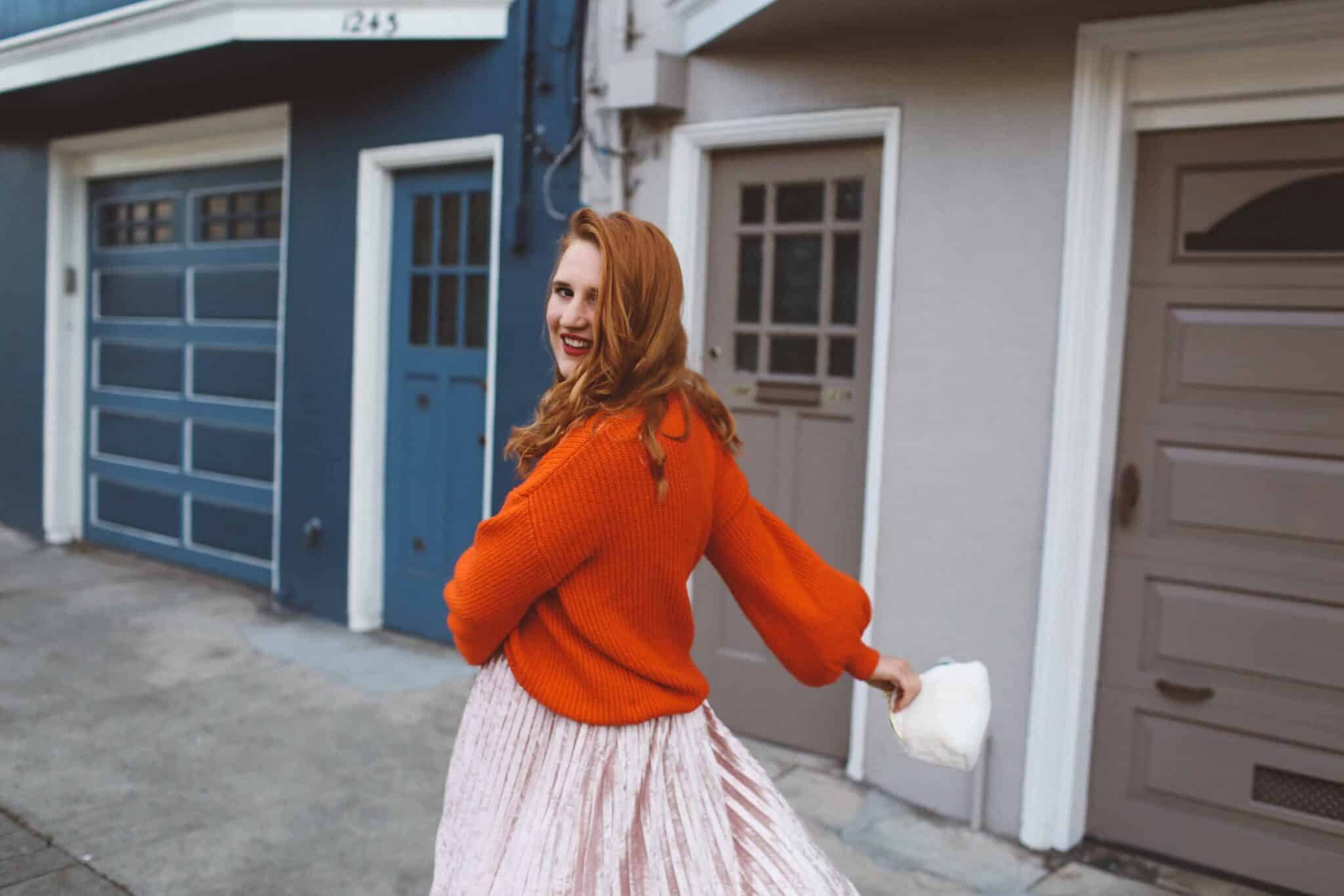 red sweater pink skirt woman white purse pink flats