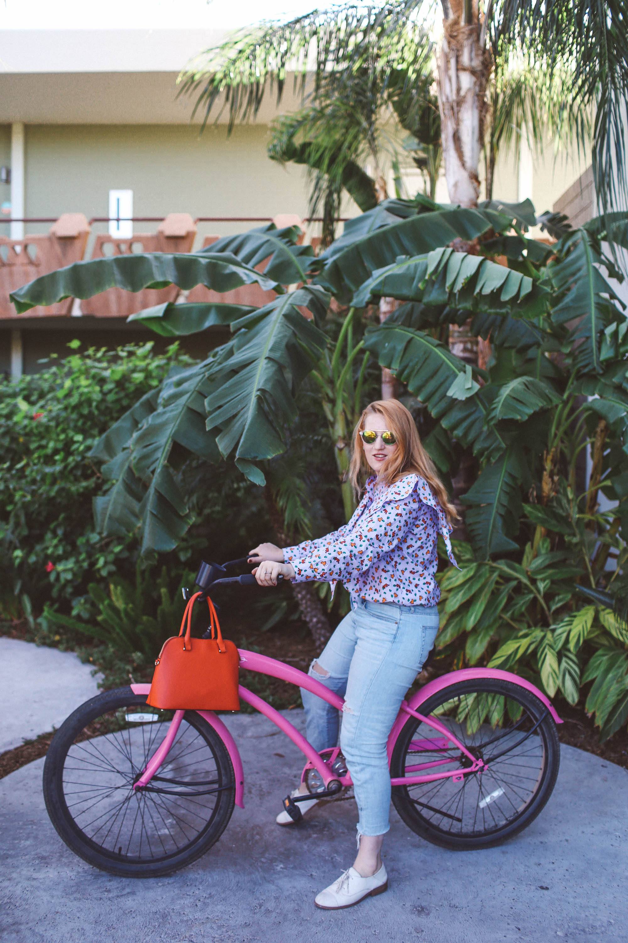 purple ruffle top pink bike palm trees