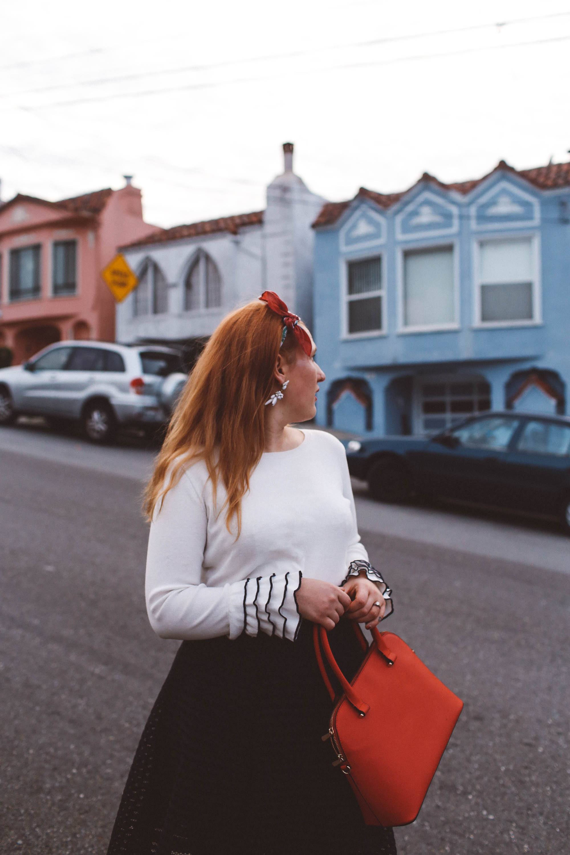 head scarf red purse black skirt ruffle sweater