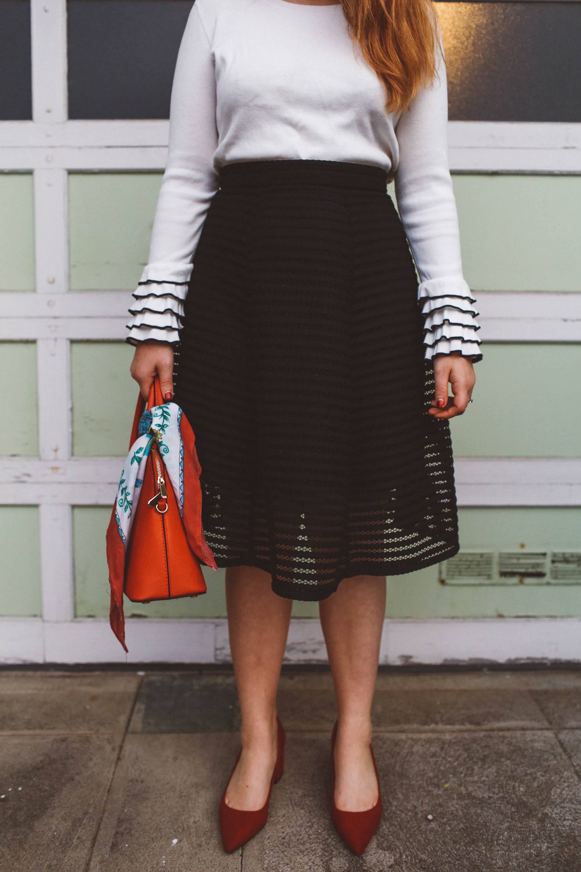 head scarf red purse black skirt ruffle sweater