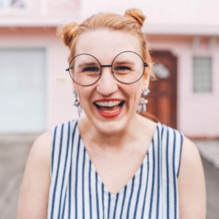 woman laughing hipster glasses