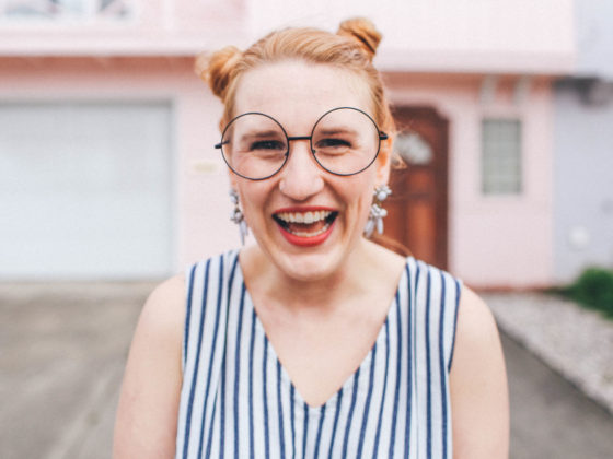 woman laughing hipster glasses