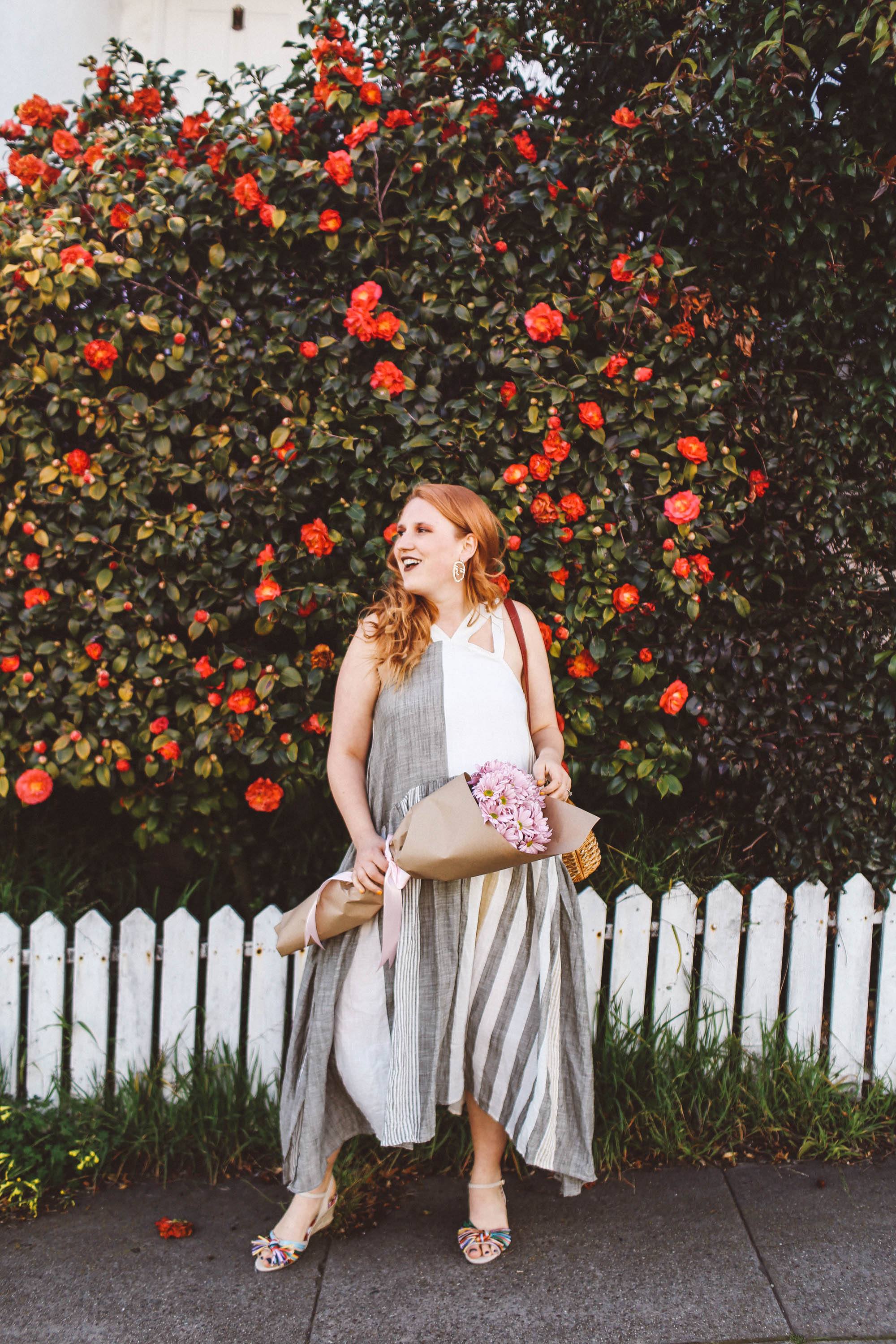 woman red hair flower wall boho dress