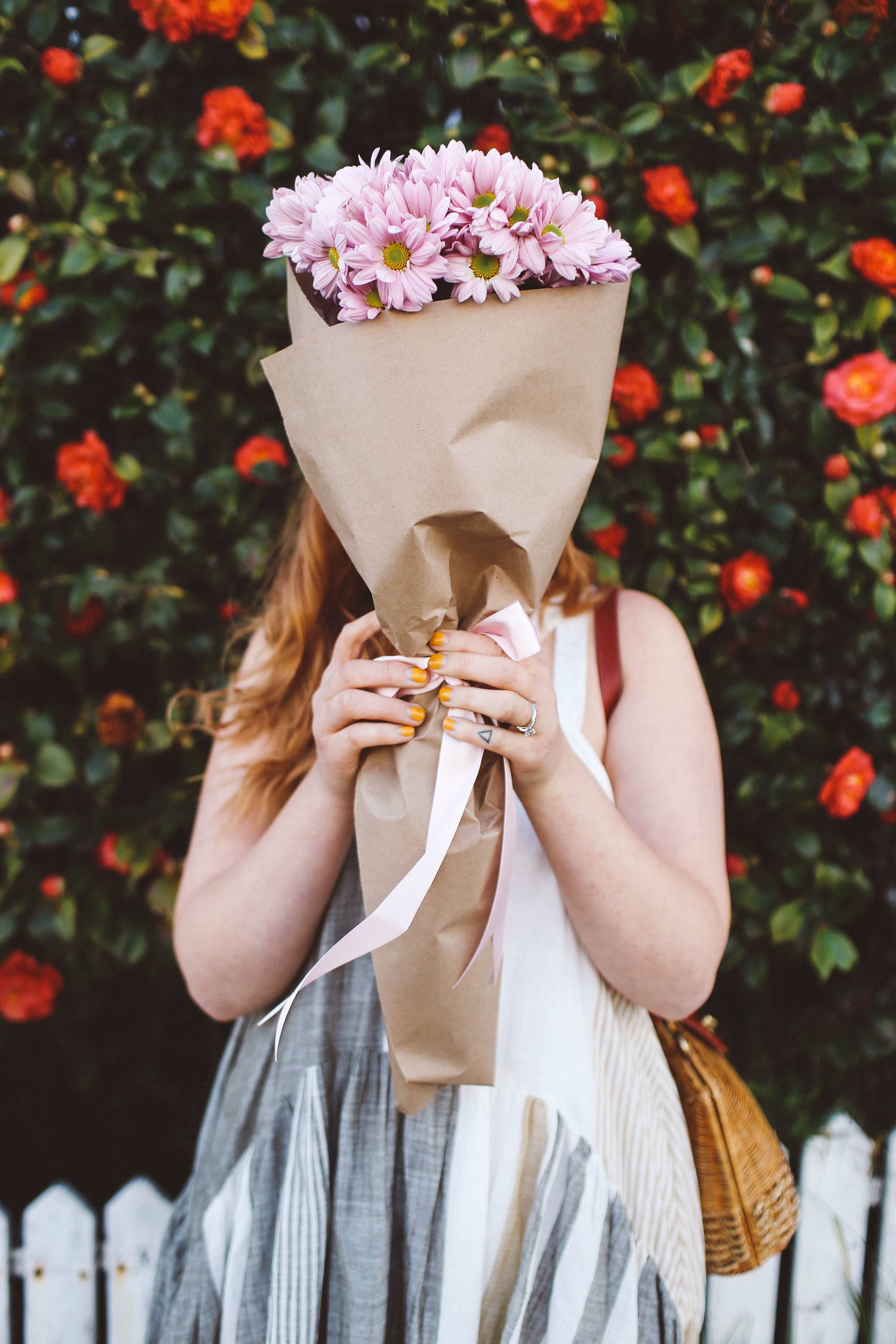 woman holding flowers face