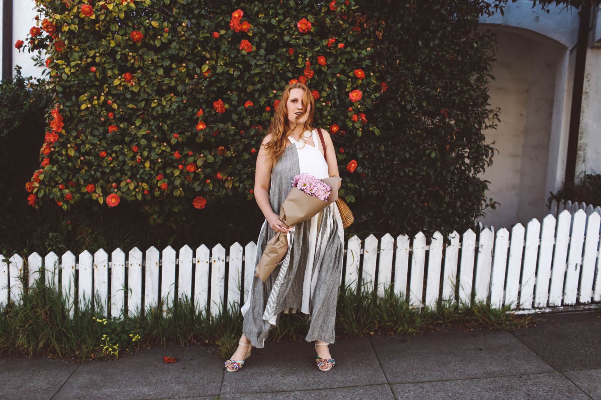 woman red hair flower wall boho dress