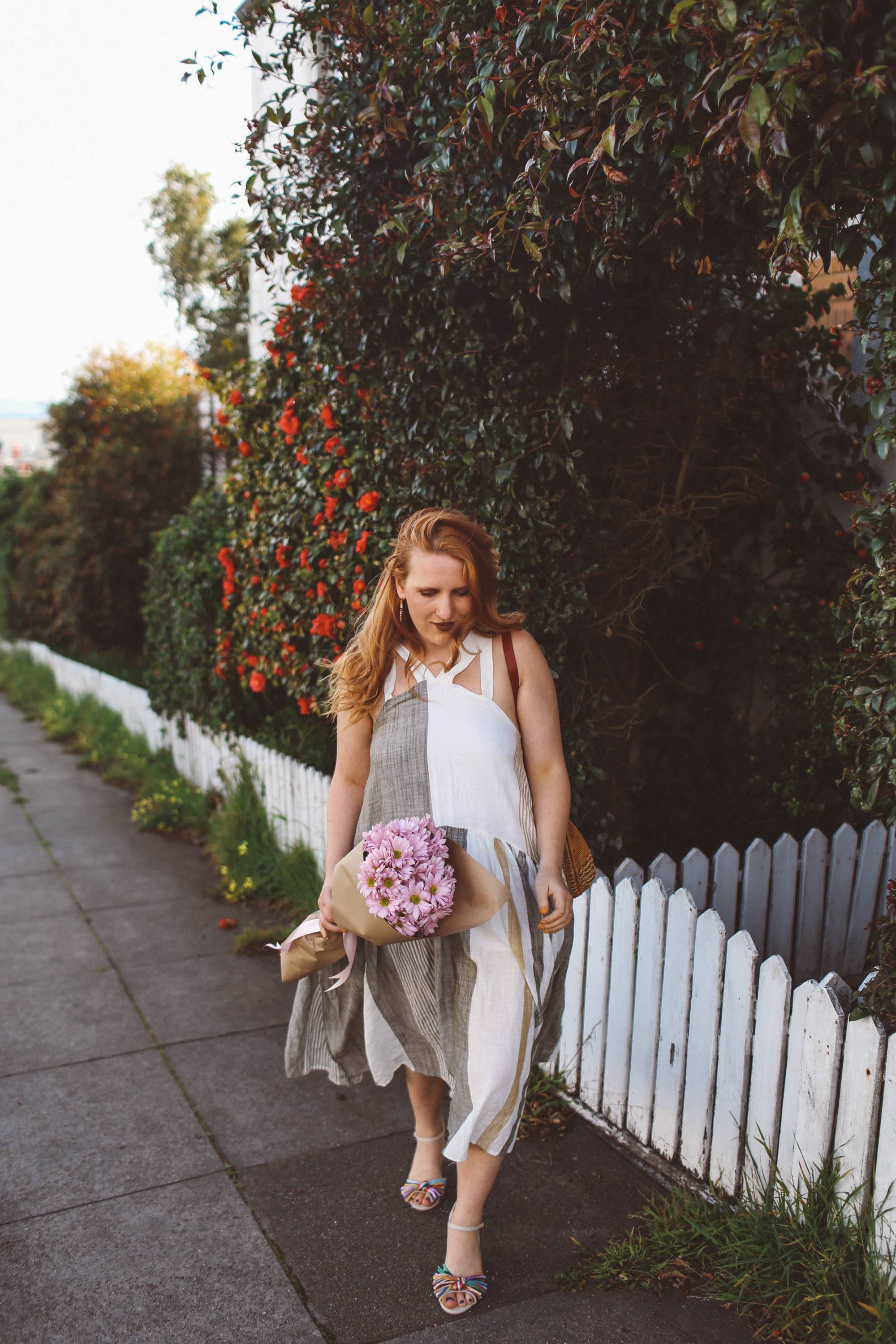 woman red hair flower wall boho dress