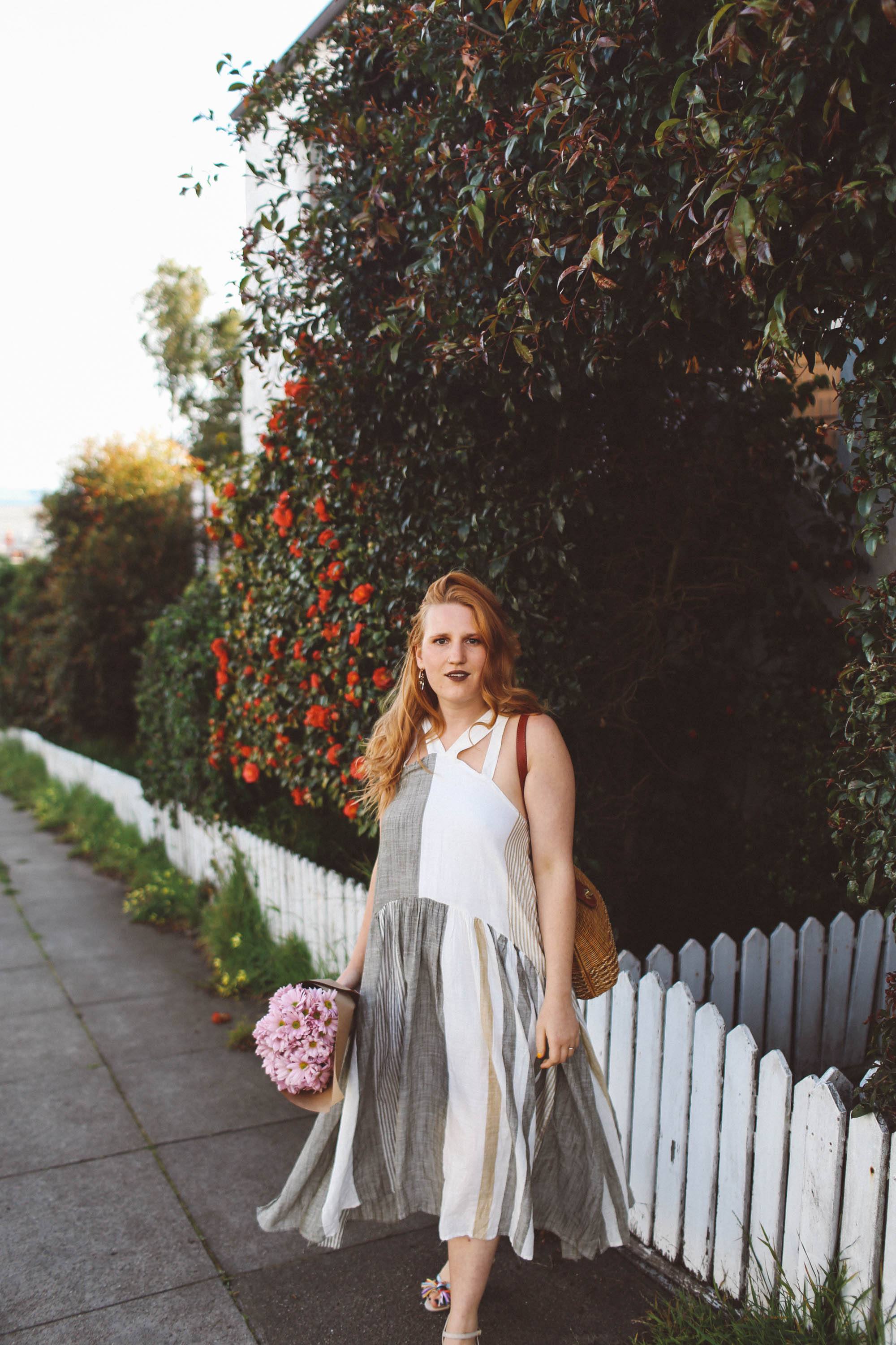 woman red hair flower wall boho dress