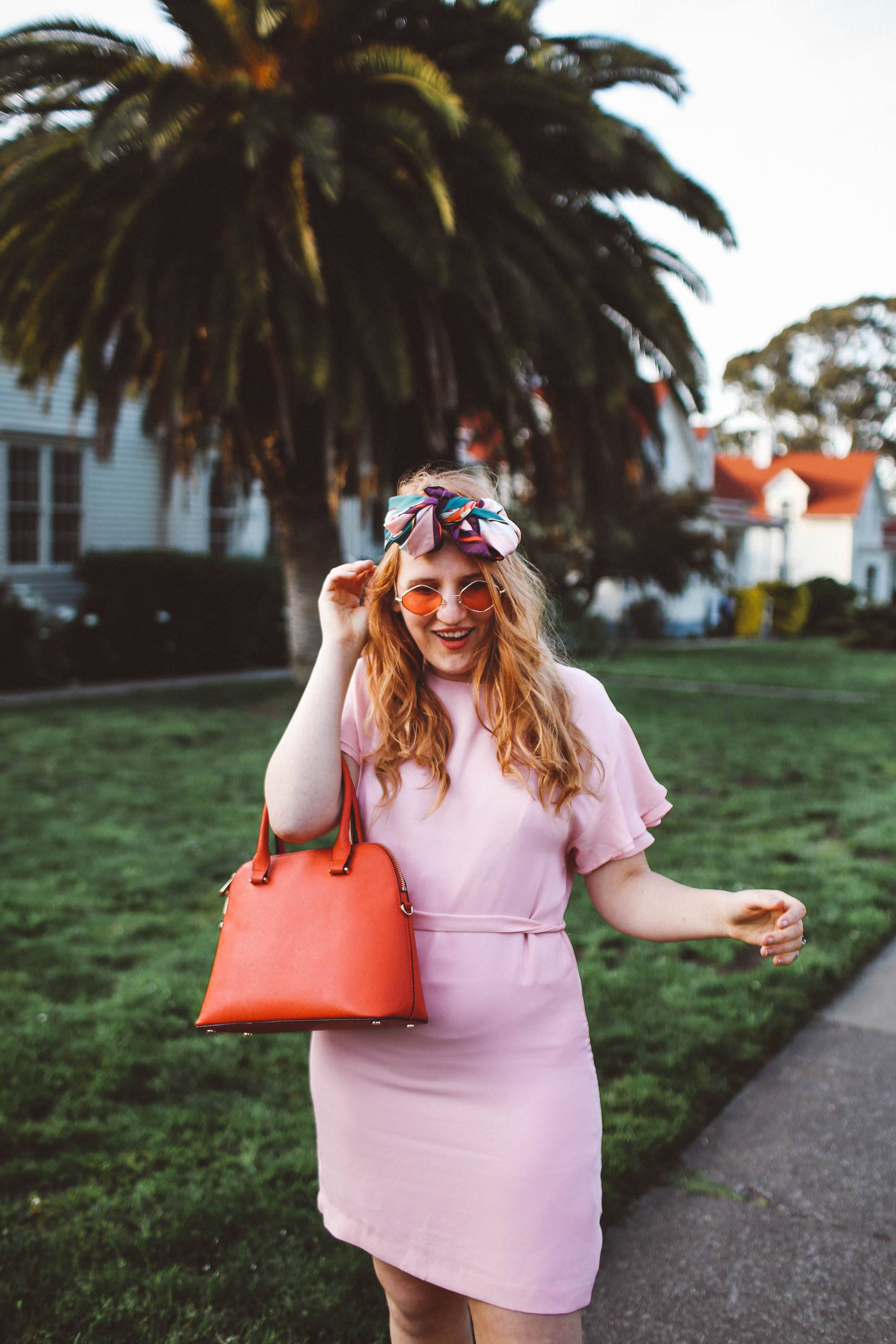 woman wearing headscarf, pink dress, pink sunglasses in San Francisco Presidio