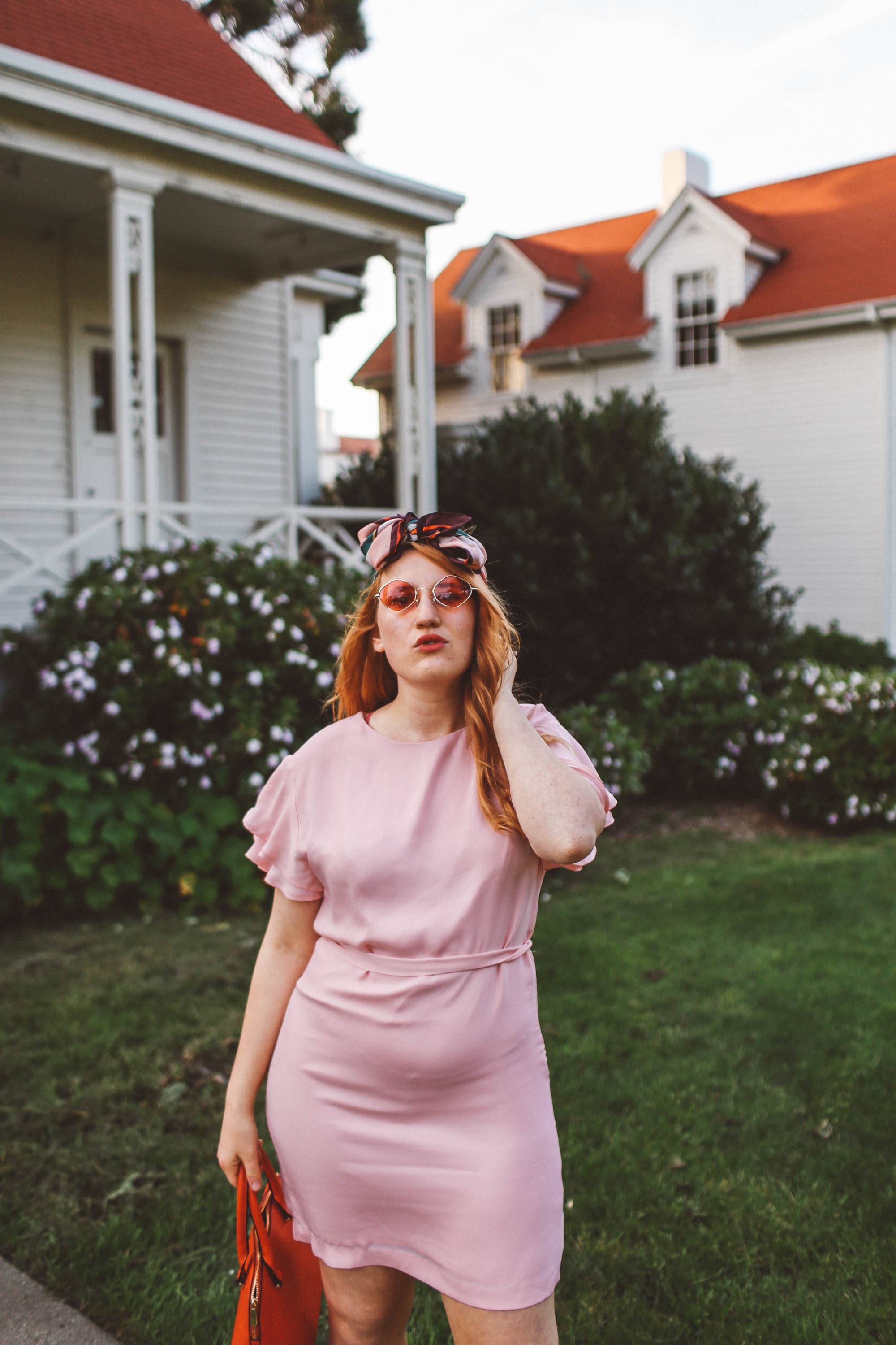 woman wearing headscarf, pink dress, pink sunglasses in San Francisco Presidio