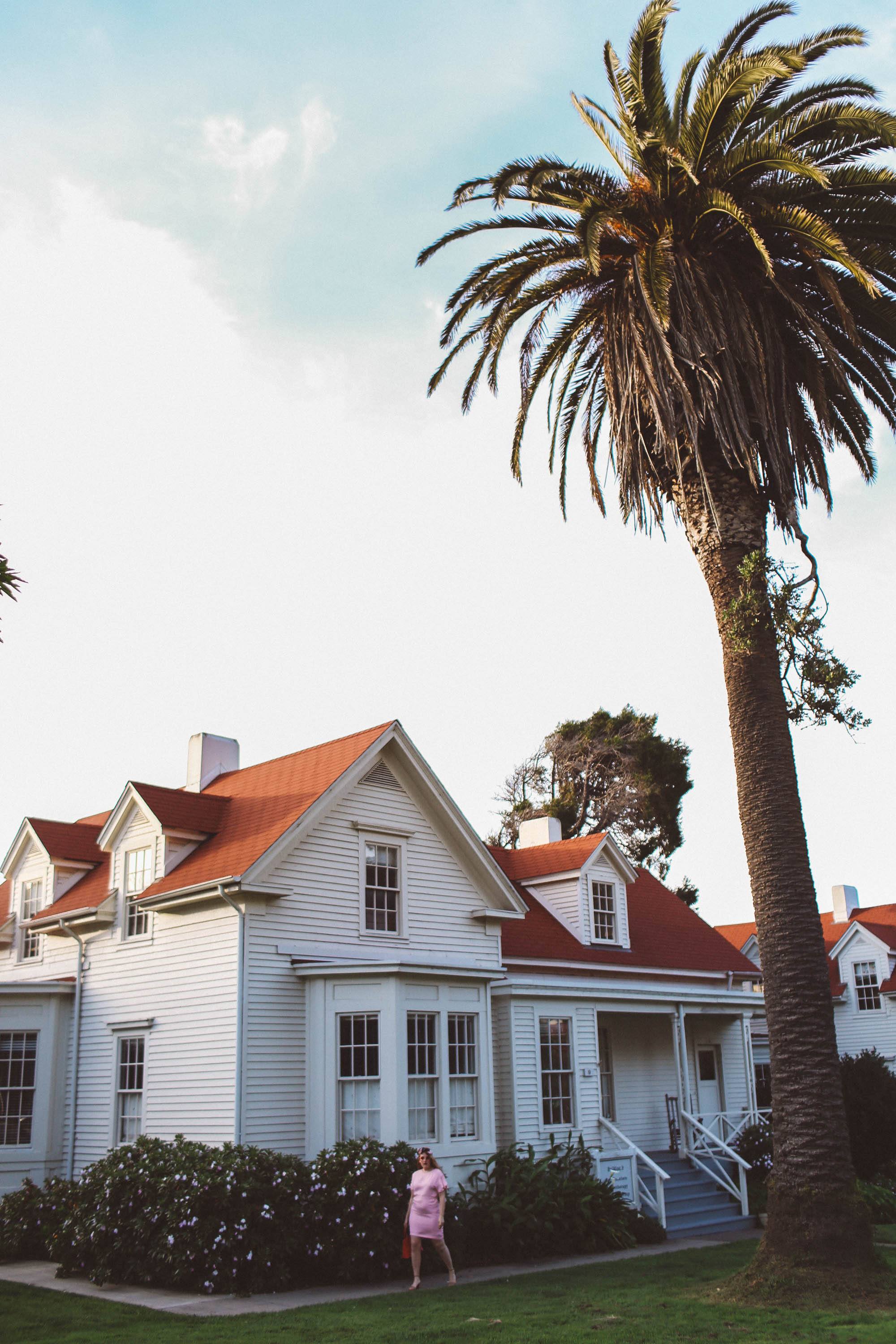 woman wearing headscarf, pink dress, pink sunglasses in San Francisco Presidio