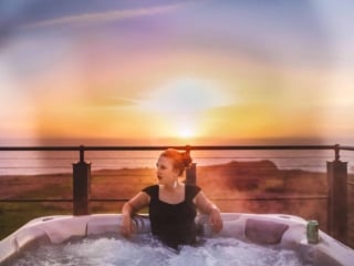 Woman in the Hot tub overlooking the coast at Newport Ranch in Mendocino