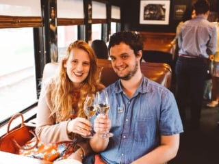 Man and woman clinking Wine Glasses on the Napa Valley Wine Train