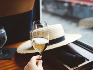 hand holding a glass of wine on the Napa Valley Wine Train