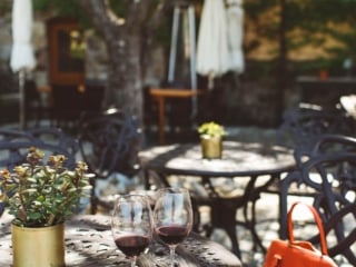 Wine glasses and a red purse on a table at a Napa Valley winery