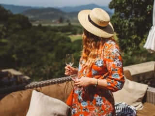 Woman in floral dress and straw hat at a Napa Valley Winery