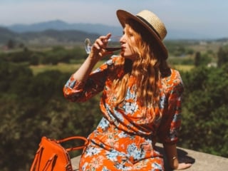 Woman in floral dress and straw hat at a Napa Valley Winery