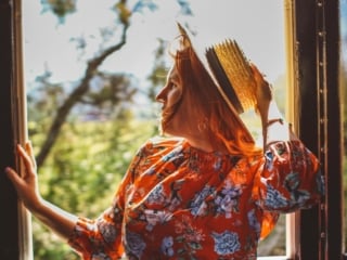 Woman in floral dress and straw on the Napa Valley Wine Train