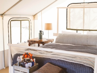 Bed and side tables in tent