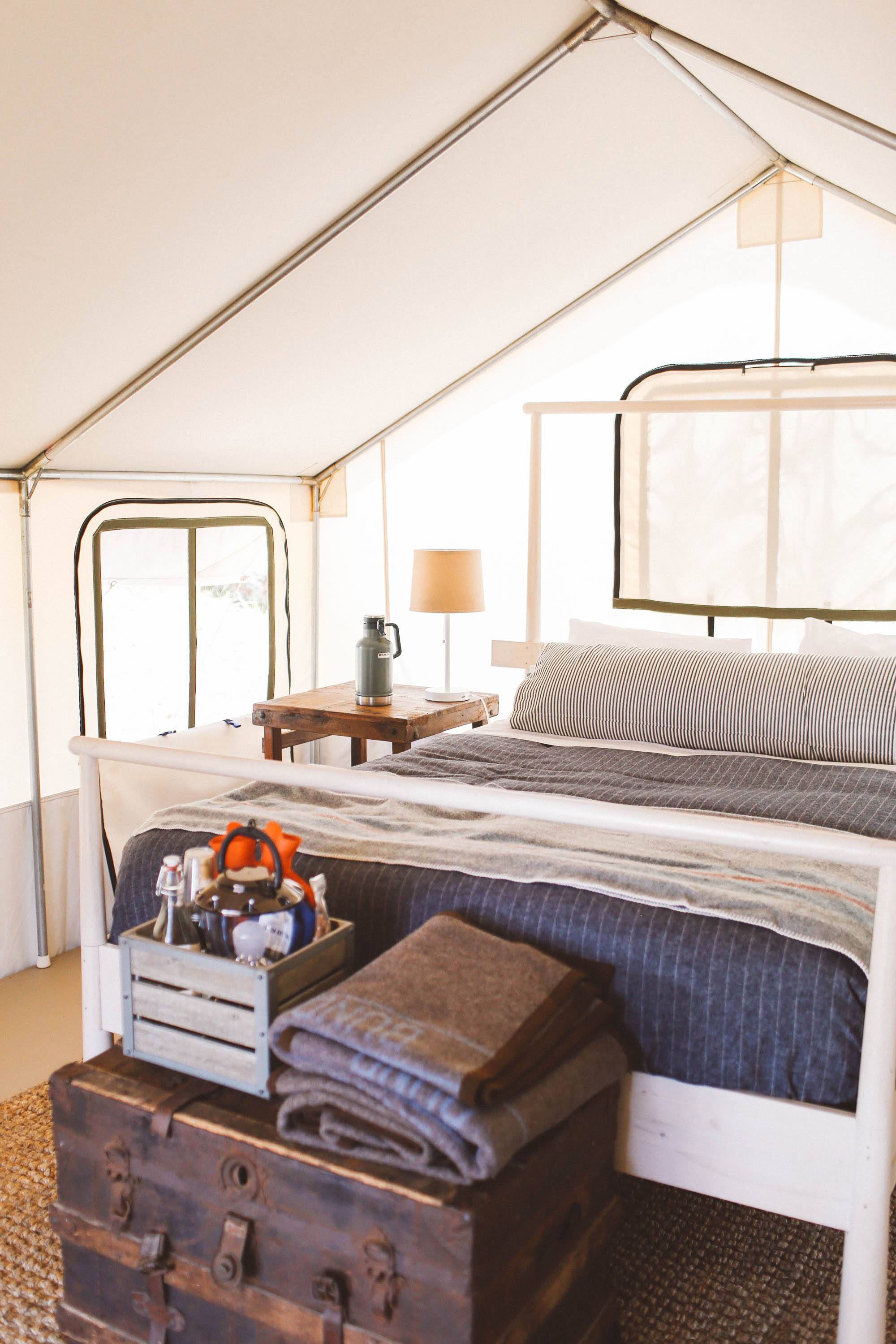 Bed and side tables in tent