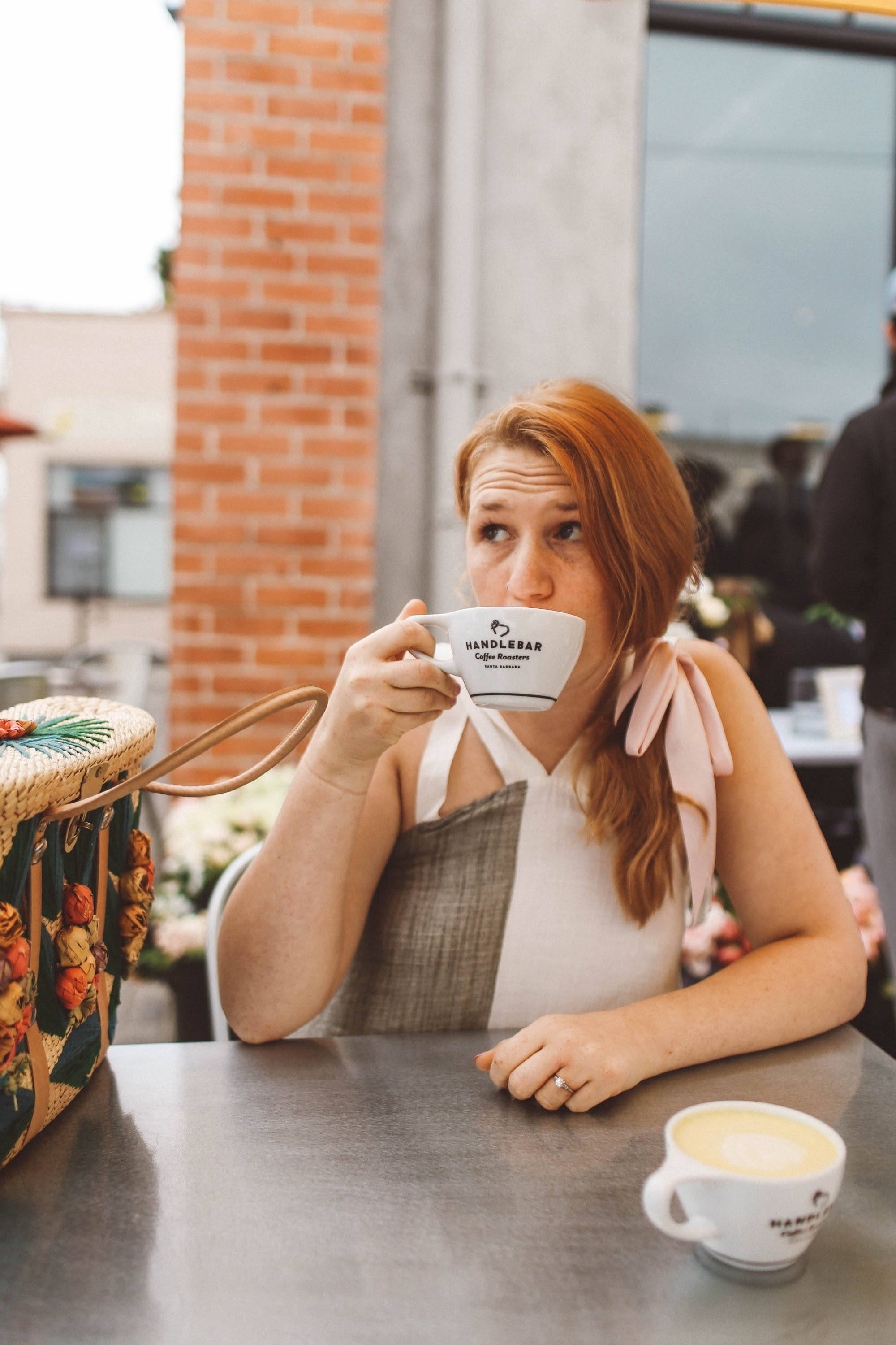 Woman drinking coffee at hanlebar coffee in Santa Barbara