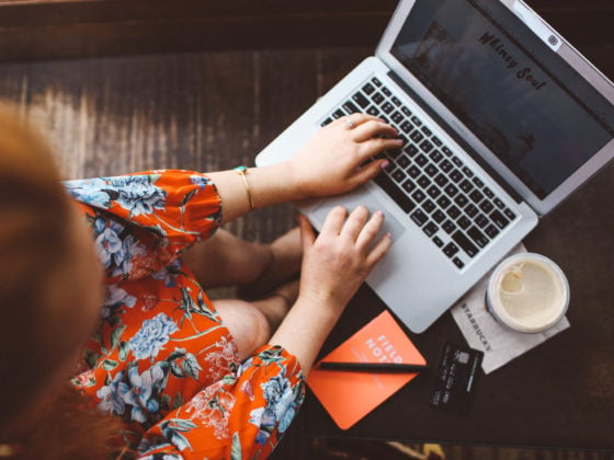 Woman in red floral dress working at Starbucks