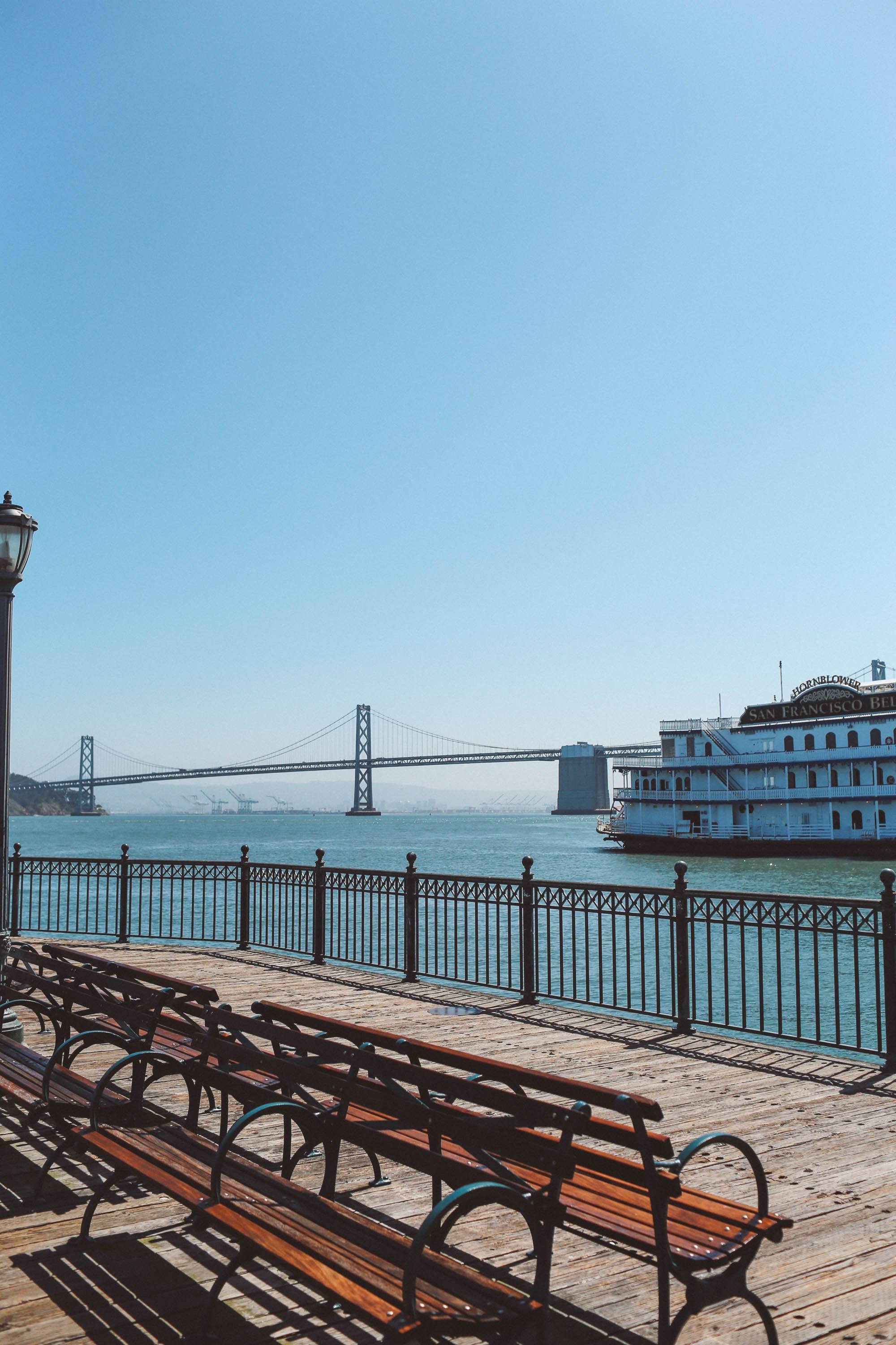 boardwalk with benches and Bay Bridge in the background