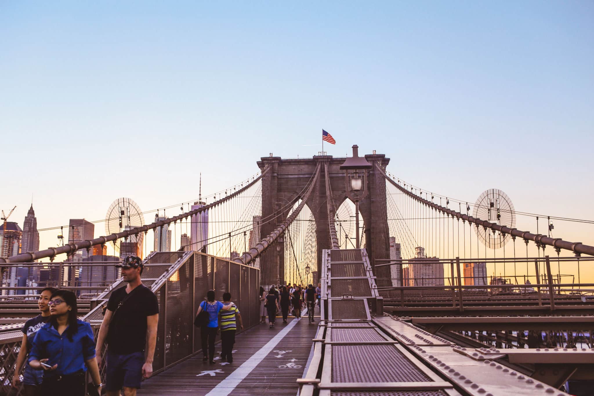 People on the Brooklyn Bridge at dusk