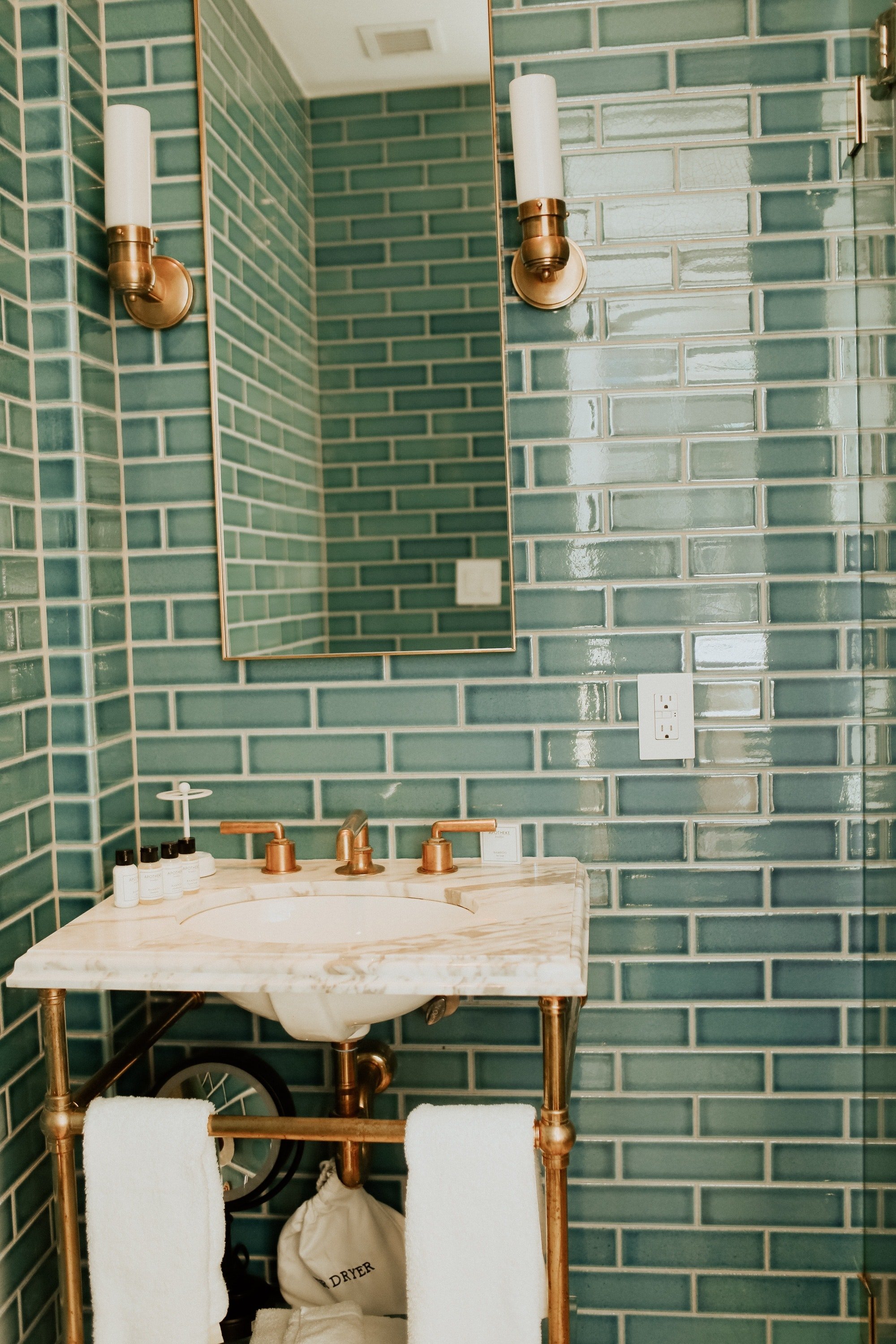 Bathroom with Turquoise wall tiles in Brooklyn hotel.