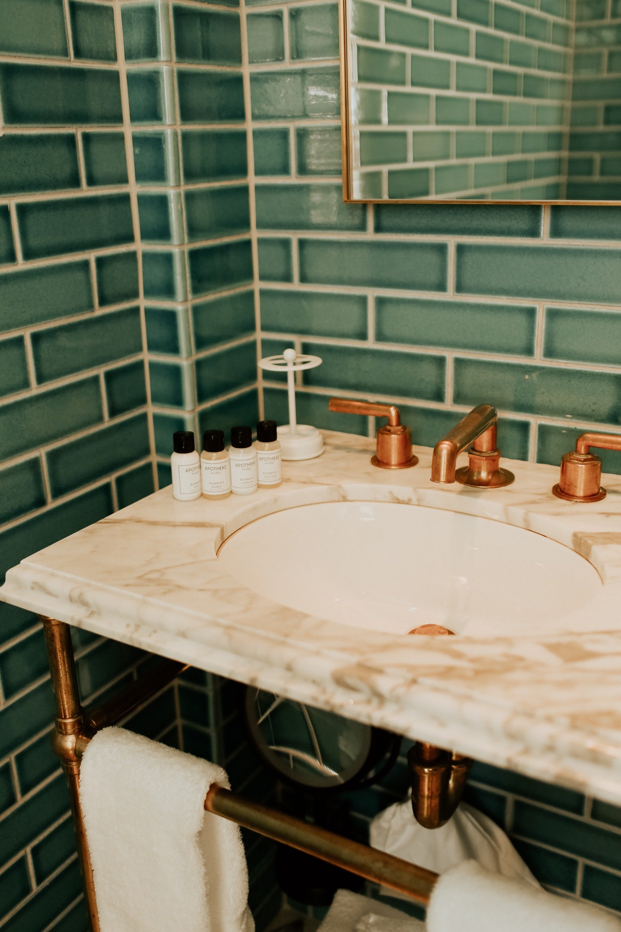 Bathroom with Turquoise wall tiles in Brooklyn hotel.