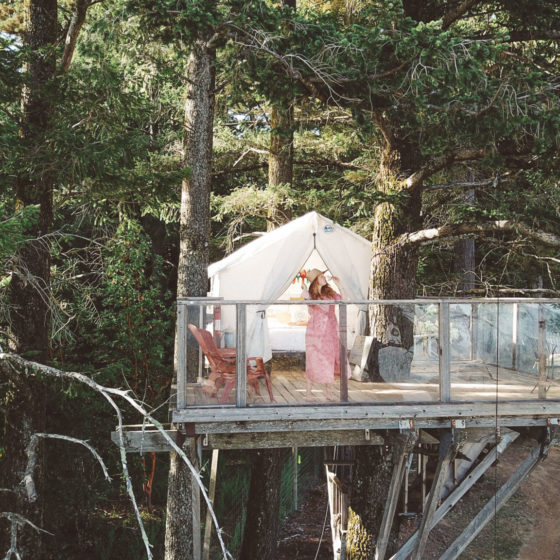 Woman drinking Wine on a treehouse Airbnb