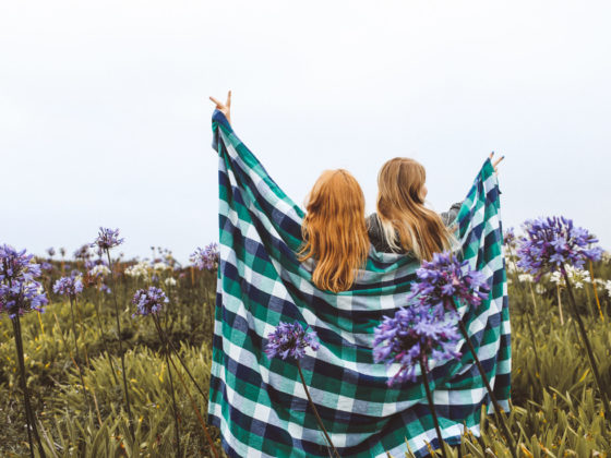 Two Women standing with blanket around them