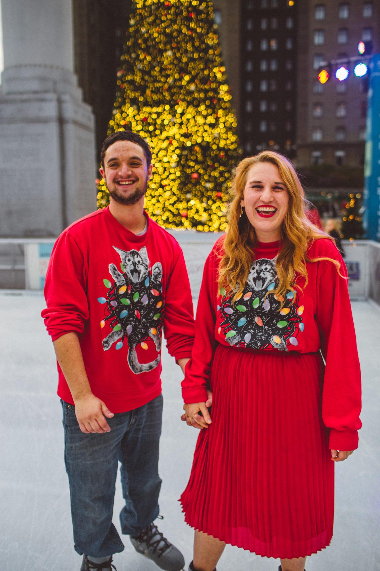 union square ice skate ugly Christmas sweater couple skating