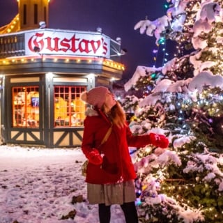 woman by christmas tree in front of gustav;s in leavenworth