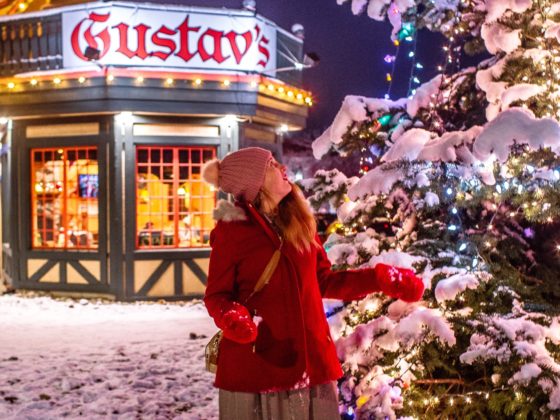 woman by christmas tree in front of gustav;s in leavenworth